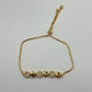 PULSERA AJUSTABLE ESTACIONES DORADAS